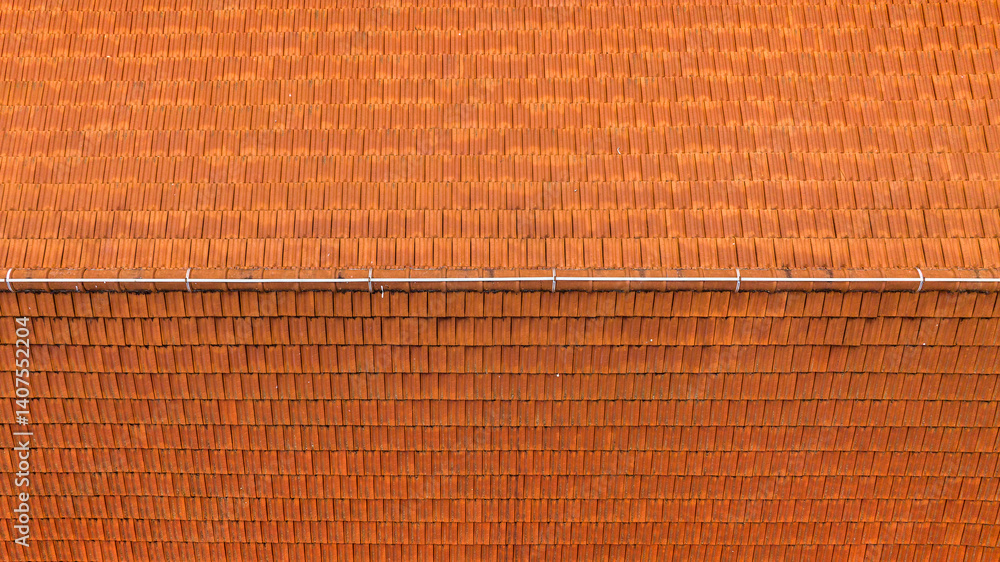 Aerial zenithal view of a roof with red tiles.