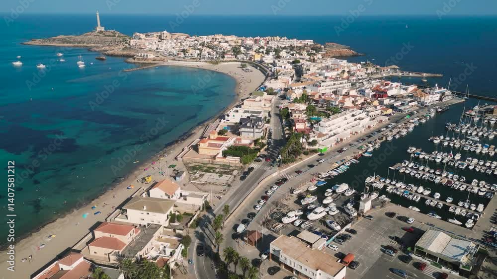 A dolly reverse aerial view of Sea port Marina with a litghhouse in the cliff on the coastal of Cabo de Palos, Murcia region - a touristic beach summer vacation in Spain A dolly reverse aerial view of Sea port Marina with a litghhouse in the cliff on the coastal of Cabo de Palos, Murcia region - a touristic beach summer vacation in Spain