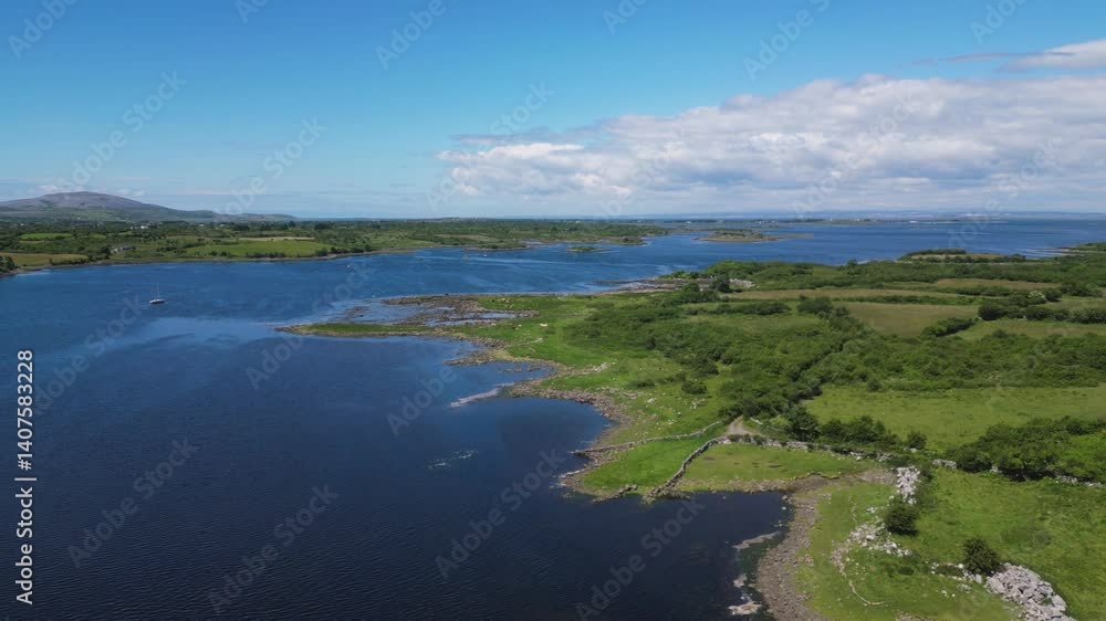 Aerial view overflying the Irish sea in the shore of Galway bay during a sunny summer day - Dunguaire Castle in Kinvarra, Co. Galway Aerial view overflying the Irish sea in the shore of Galway bay during a sunny summer day - Dunguaire Castle in Kinvarra, Co. Galway