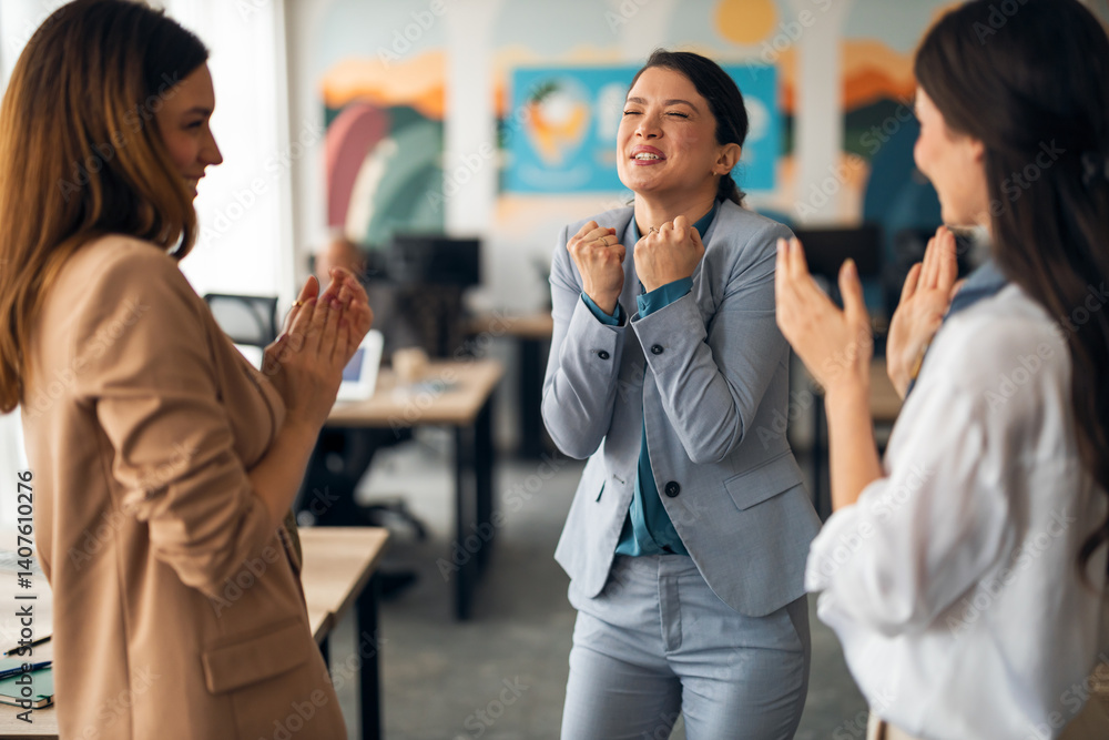 Excited Businesswoman Celebrating Success in Collaborative Modern Office Environment