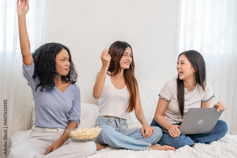 Diverse group of women friends smiling and talking while using laptop, browsing social media, shopping online, watching movies or series enjoying entertainment and connection digital lifestyle at home Diverse group of women friends smiling and talking while using laptop, browsing social media, shopping online, watching movies or series enjoying entertainment and connection digital lifestyle at home