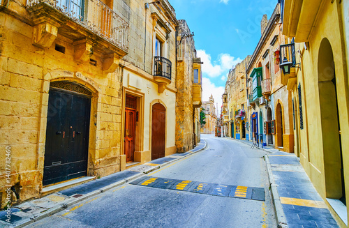 Narrow St Paul street and St Paul Parish Church on the background in Rabat, Malta