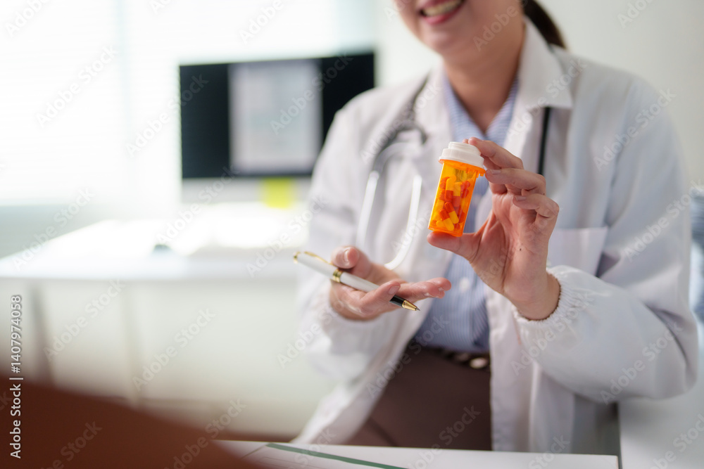 Smiling female doctor holding a pill container and a pen, prescribing medicine to a patient in her bright office Smiling female doctor holding a pill container and a pen, prescribing medicine to a patient in her bright office