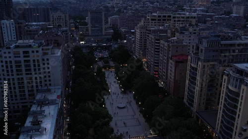 bustling avenue lined with trees and high-rise buildings in a calm evening in Yerevan, Armenia