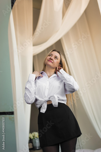 Young woman looking at herself in the mirror