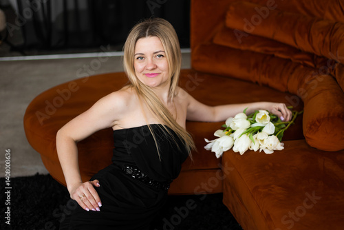 A woman holds white tulips in her hands