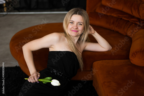 A woman holds white tulips in her hands