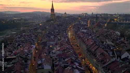 Illuminated City of Bern in Switzerland from above in Night Twilight - the Capital city Evening view. Aerial Drone shot.