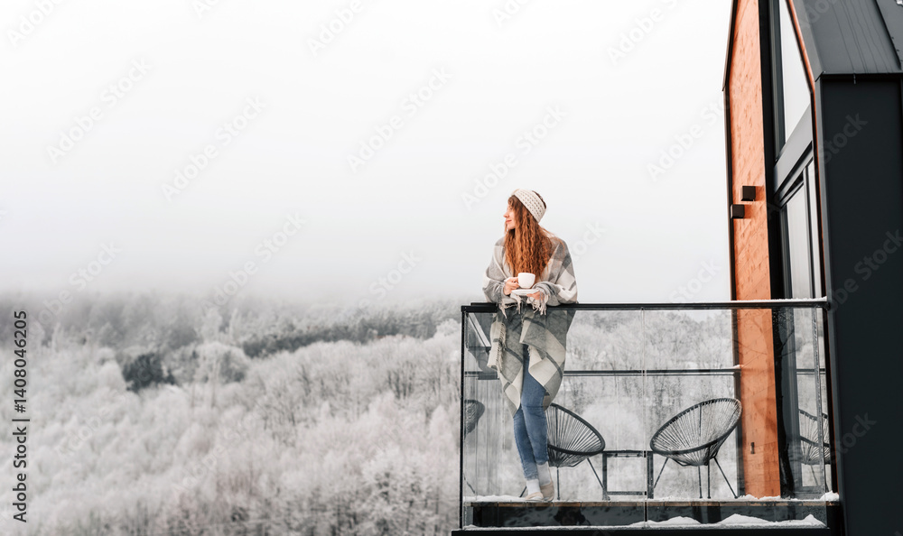 Woman on Terrace of Scandinavian Rustic Cabin in Winter