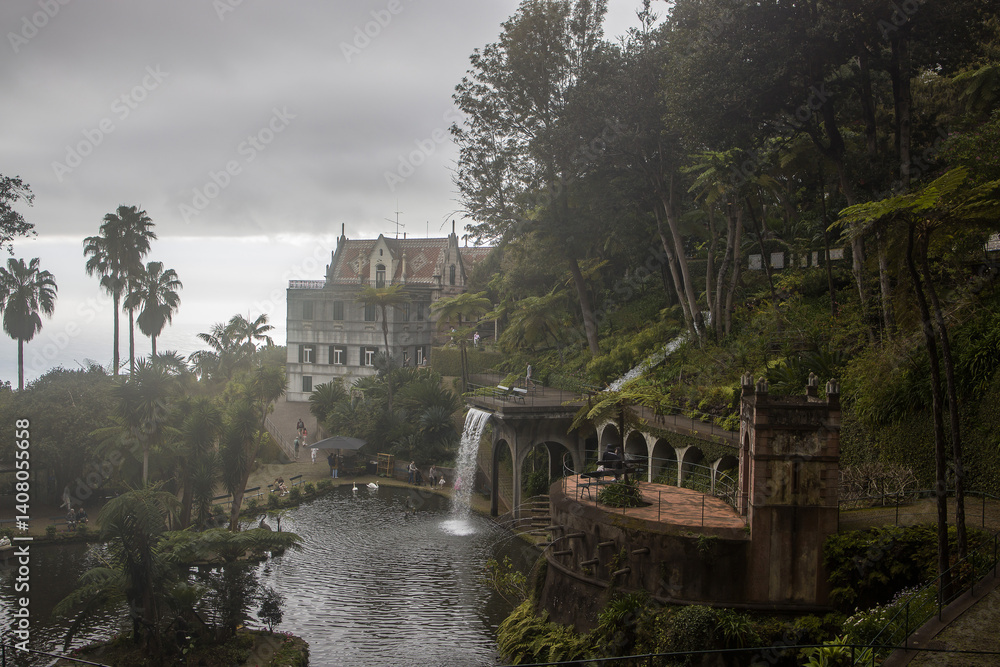 Scenic view of Monte Palace Garden in Madeira featuring lush greenery and an elegant mansion amidst a cloudy sky