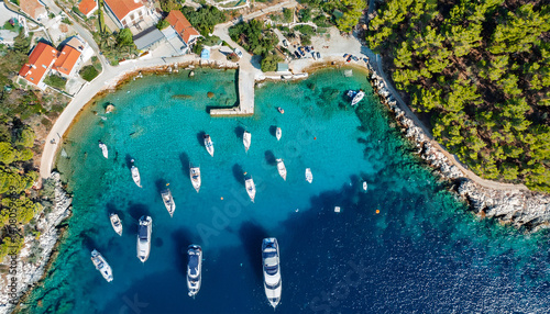 a breathtaking top down aerial view of maslinica bay on solta island croatia capturing the turquoise adriatic sea boats in the marina and the villagers waterfront