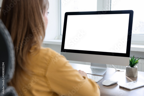 Woman working on computer at desk in office. Mockup for design