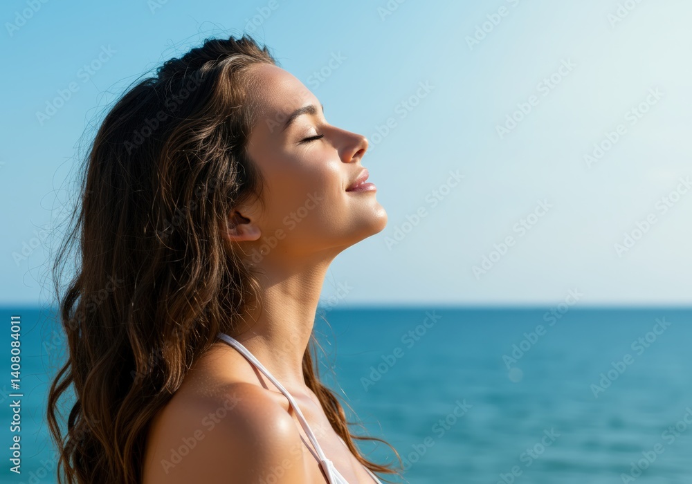 A serene woman enjoying the warmth of the sun near the ocean with eyes closed in bliss. A serene woman enjoying the warmth of the sun near the ocean with eyes closed in bliss.