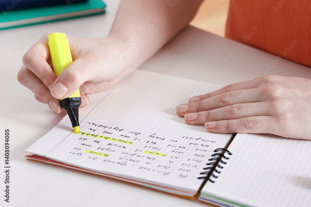 Woman highlighting important information at white desk indoors, closeup Woman highlighting important information at white desk indoors, closeup