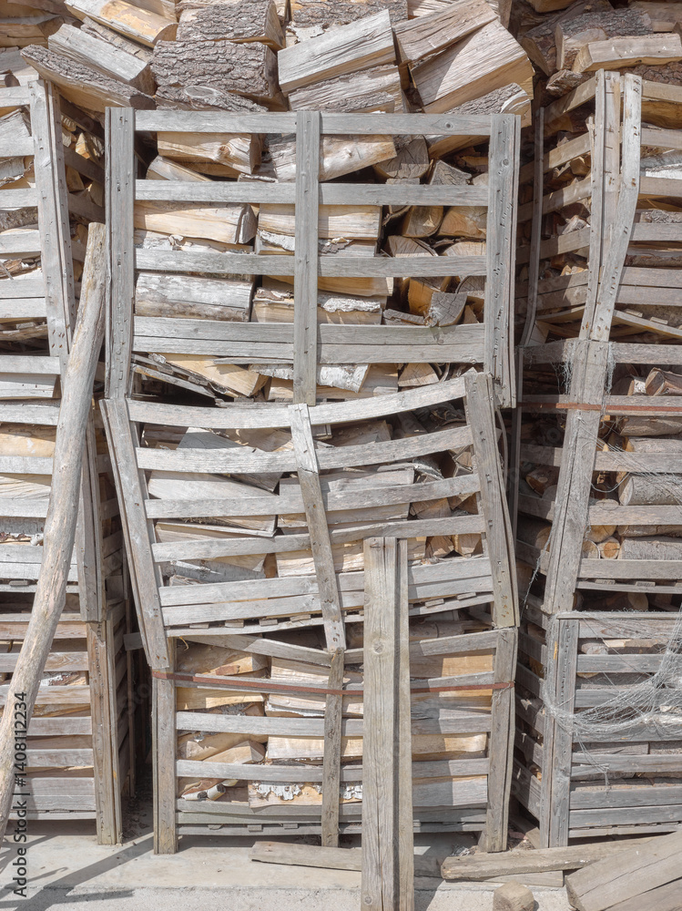 Wooden crates containing chopped firewood.