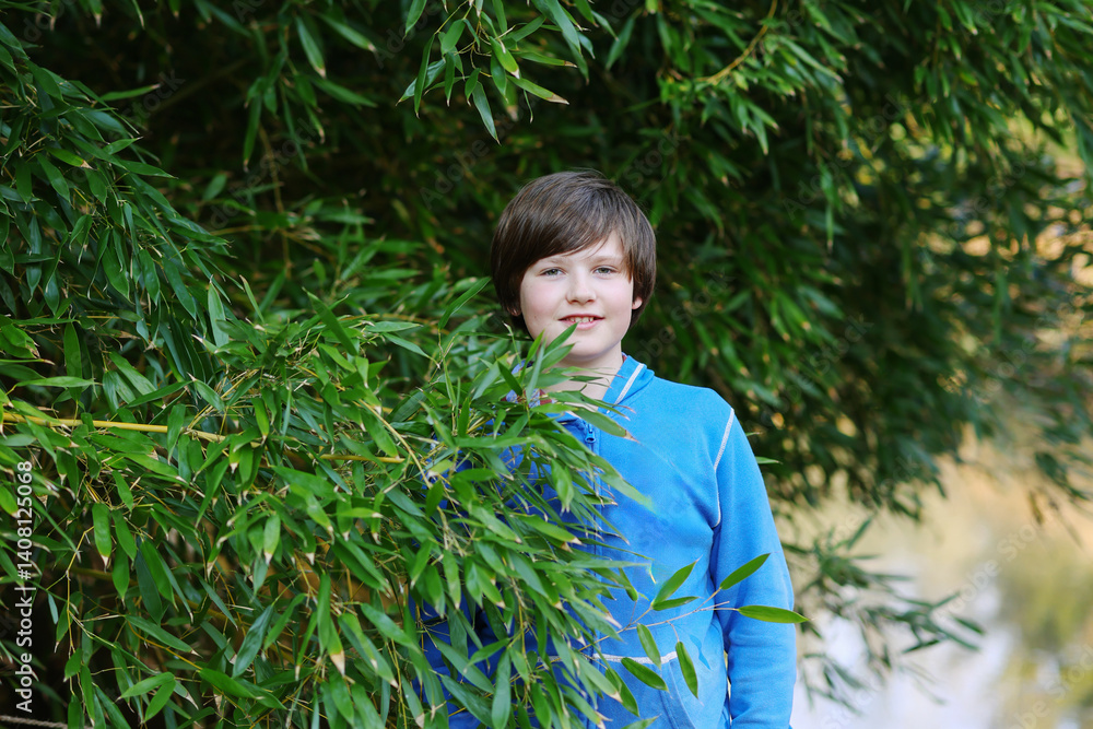 Springtime joy happy boy enjoying nature and fresh air among blooming magnolias. Springtime joy happy boy enjoying nature and fresh air among blooming magnolias.