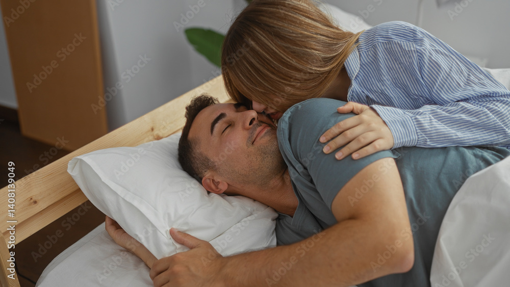 Couple embracing lovingly in a cozy bedroom, woman lying beside man showing intimate affection, their comforting home environment accentuating warmth and happiness.