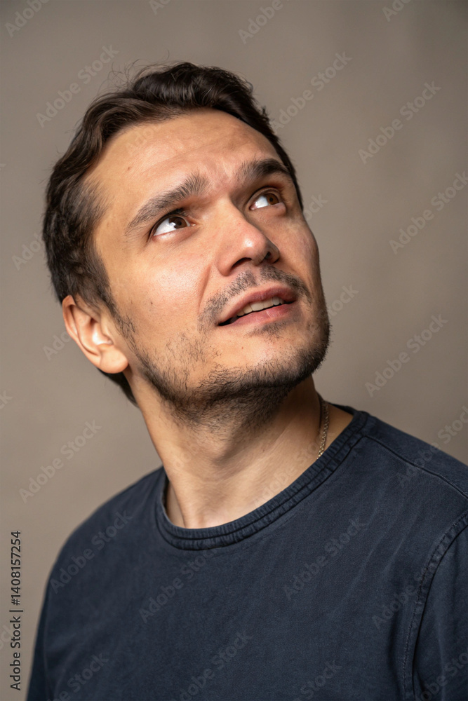 Fototapeta premium A close-up portrait of a man with striking facial features and deep, expressive eyes. A mix of strength, character, and emotion captured in a single moment