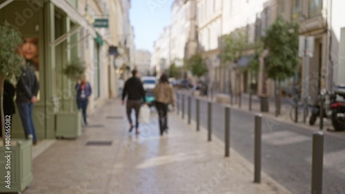 Obraz na płótnie Blurred image of a street in marseilles featuring a man and woman walking outdoors with a bokeh effect in the background, capturing a vibrant european city atmosphere. w salonie