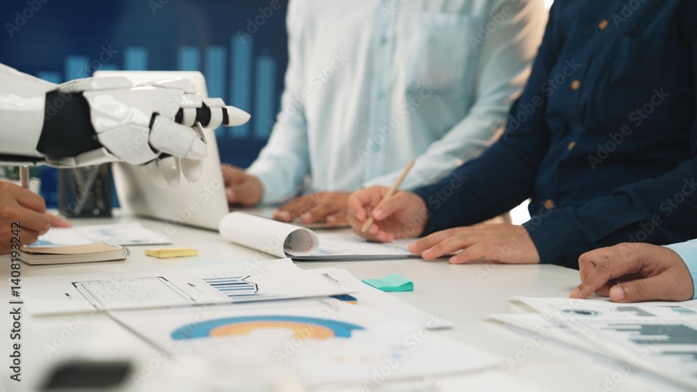 A dynamic business meeting featuring a robot assisting in data analysis. Hands are engaged in discussions, surrounded by charts and documents on the table.Noogenesis