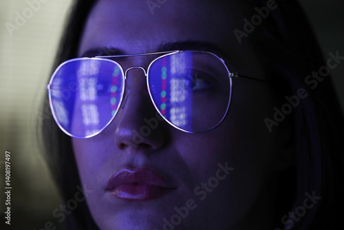 Obraz na płótnie Young woman wearing glasses with reflection on dark background, closeup w salonie