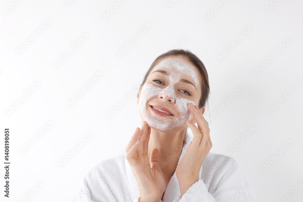 Spa day. Beautiful woman applying mask onto her face on white background Spa day. Beautiful woman applying mask onto her face on white background