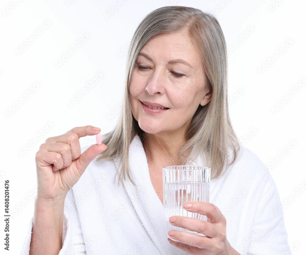 Smiling woman with collagen pill and glass of water on white background Smiling woman with collagen pill and glass of water on white background