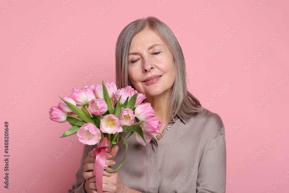 Beautiful woman with bouquet of tulips on pink background Beautiful woman with bouquet of tulips on pink background