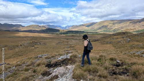 Obraz na płótnie Young woman hiker backpacker hiking at Lackavrea mountain at Maum, Connemara national park, Galway, Ireland, nature adventure background w salonie
