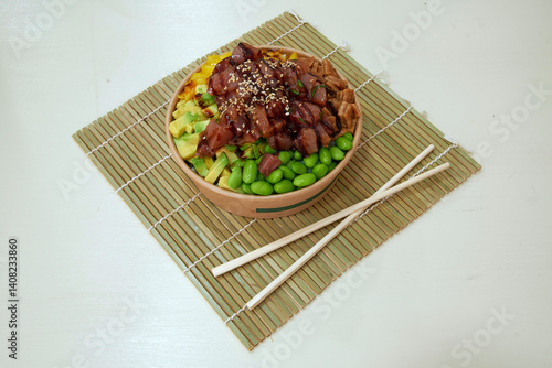 A bowl of food with chopsticks on top. The food is a mix of meat and vegetables