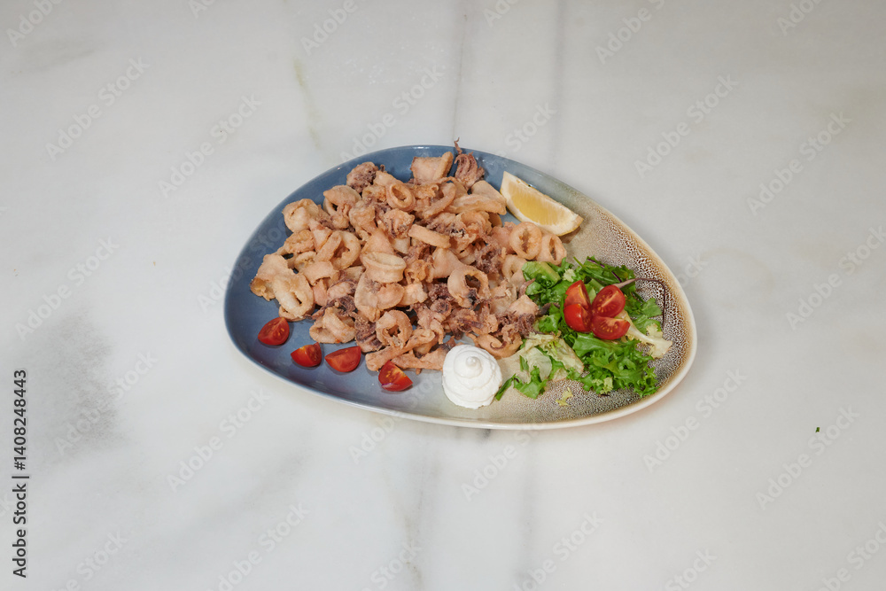 A plate of food with a blue plate and a white plate. The white plate has a dish of food with a green salad