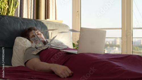 Man sleeping as money flies from laptop passive income concept. Passive income money while you sleep digital business success. Cash flying from screen. Money rain. Lazy earn