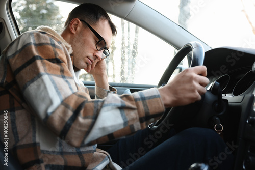 Tired driver sleeping in his modern car