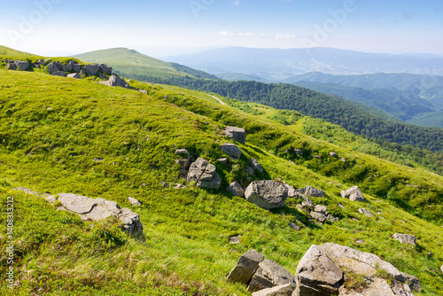 Obraz na płótnie white sharp stones on the hillside. lovely carpathian mountain landscape in summer. huge rocks scattered among alpine grass. stunning terrain of smooth mountain. heavy sandstone on the meadow w salonie