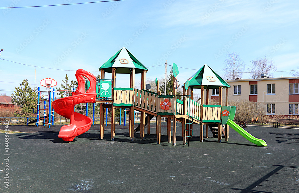 Naklejka premium Russia, Saint Petersburg, April 14, 2025. Children's playground with various play structures in a village in Russia, Leningrad region. Play structures of houses for sports development of children.