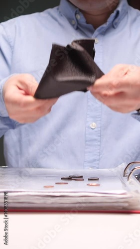 vertical video Businessman emptying wallet with last coins falling on desk at office