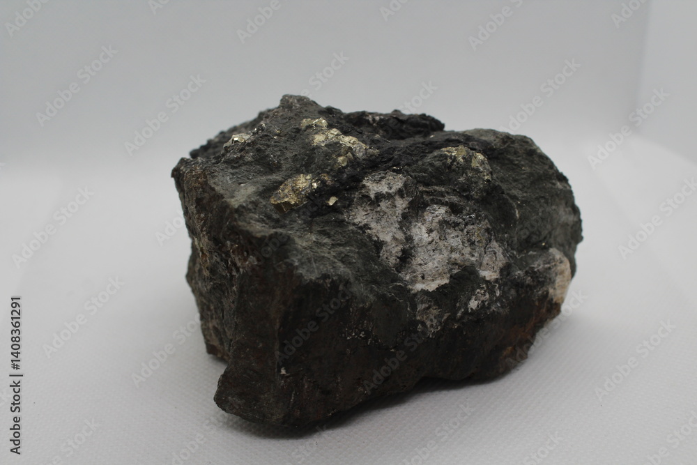 Pyrite in a rock isolated on a white background. natural silver pyrite gem on white background. Pyrrhotite or Pyrite from Baska, Frydek Mistek, Czech republic Pyrite in a rock isolated on a white background. natural silver pyrite gem on white background. Pyrrhotite or Pyrite from Baska, Frydek Mistek, Czech republic