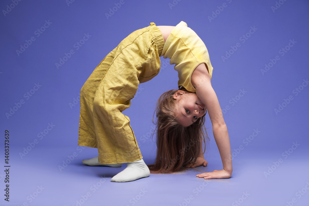 Girl in stylish clothes dancing on purple background