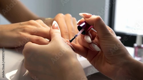 Hands display elegant nail art at a beauty studio