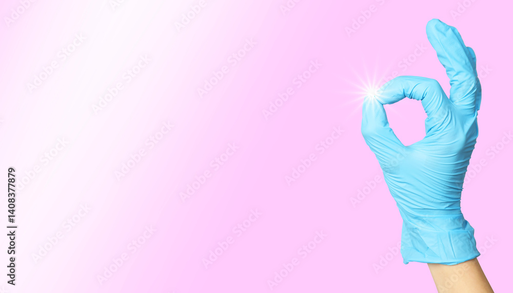 Cleaning service worker in rubber glove showing ok gesture on pink background, closeup. Shine of purity on finger Cleaning service worker in rubber glove showing ok gesture on pink background, closeup. Shine of purity on finger
