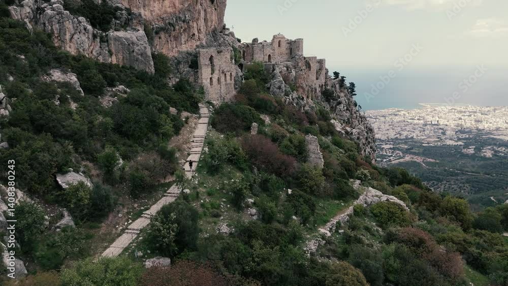 Aerial drone view of St. Hillarion Castle ruins and winding path overlooking the Kyrenia coast in Northern Cyprus Aerial drone view of St. Hillarion Castle ruins and winding path overlooking the Kyrenia coast in Northern Cyprus