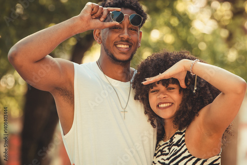 young latin couple outdoors looking
