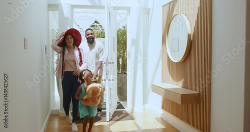 Diverse family taking selfie at vacation home entrance with rolling luggage and teddy bear