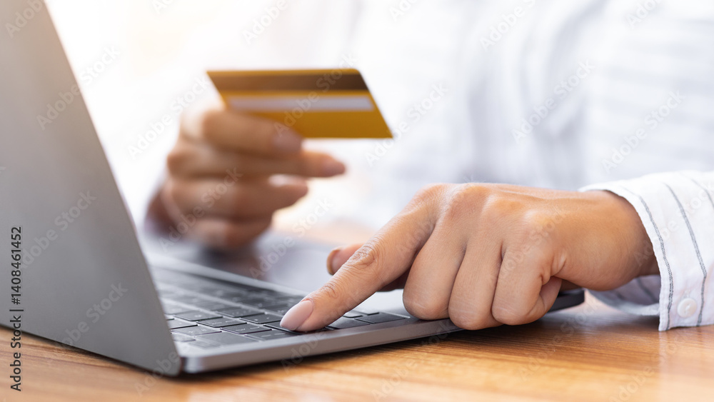 Unrecognizable millennial person shopping in internet on personal computer, using credit card to pay, closeup Unrecognizable millennial person shopping in internet on personal computer, using credit card to pay, closeup