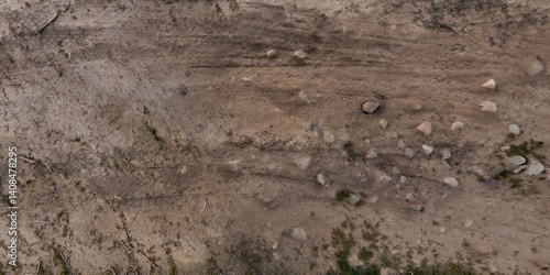 Obraz na płótnie view from above on surface of texture of dry road with tractor tire tracks in countryside w salonie
