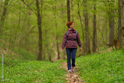 Woman hiking on forest trail