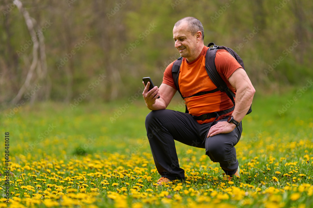 Man using phone in flower meadow