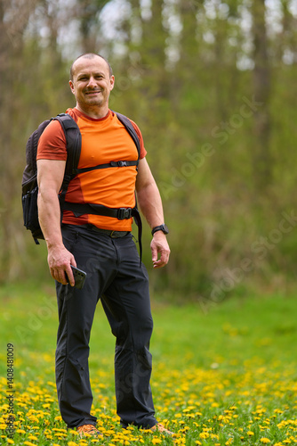 Obraz na płótnie Happy man hiking in spring meadow w salonie