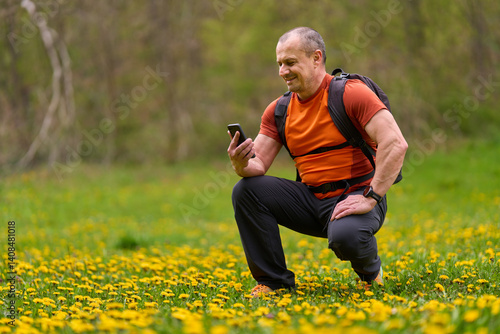 Man using phone in flower meadow