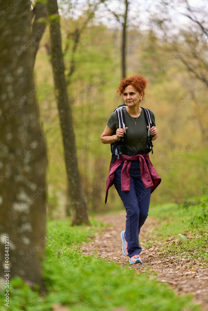 Woman hiking in spring forest